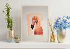 Framed artwork of a flamingo on a shelf with decorative items.