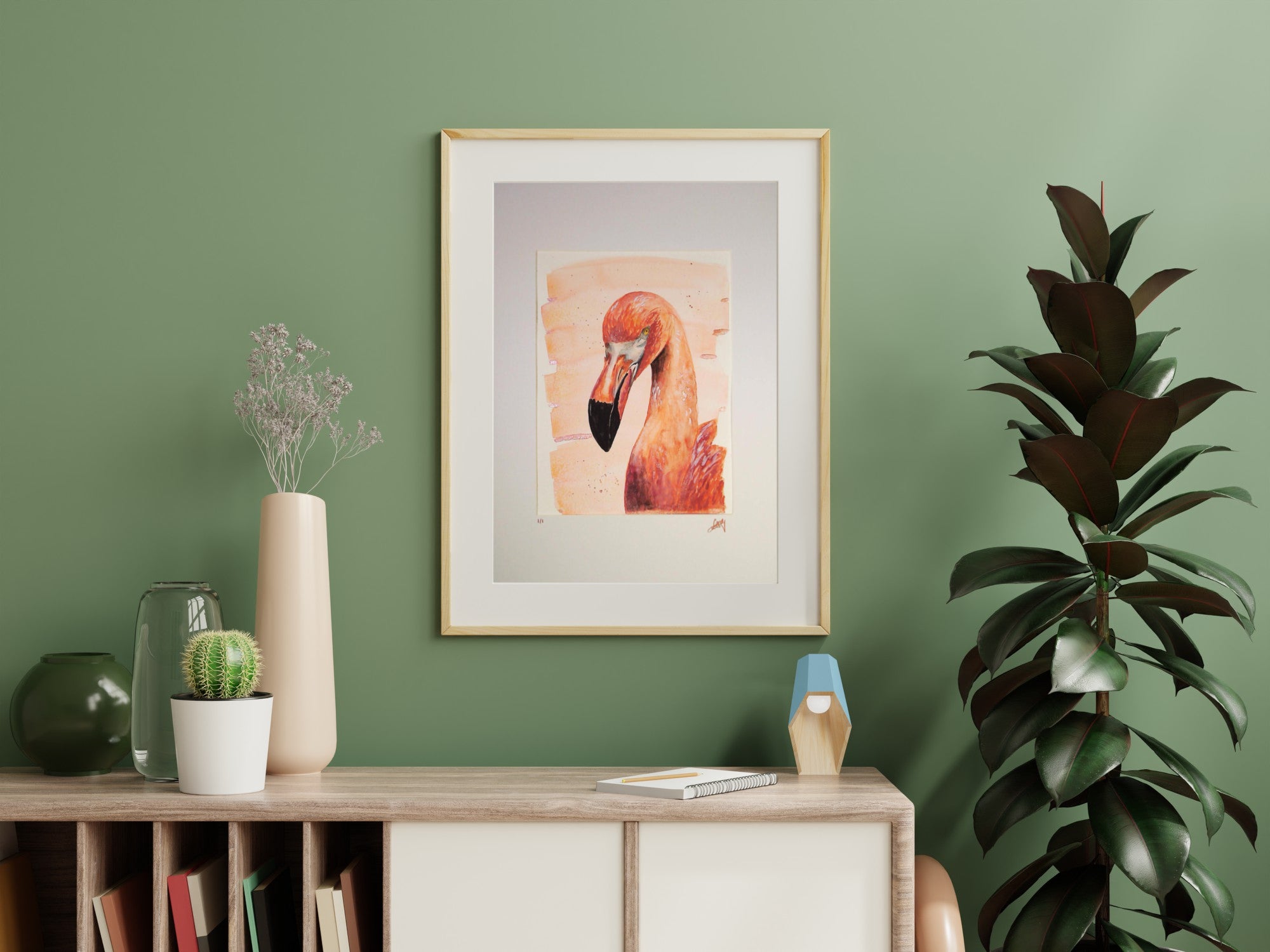 Flamingo artwork on a green wall with decorative items