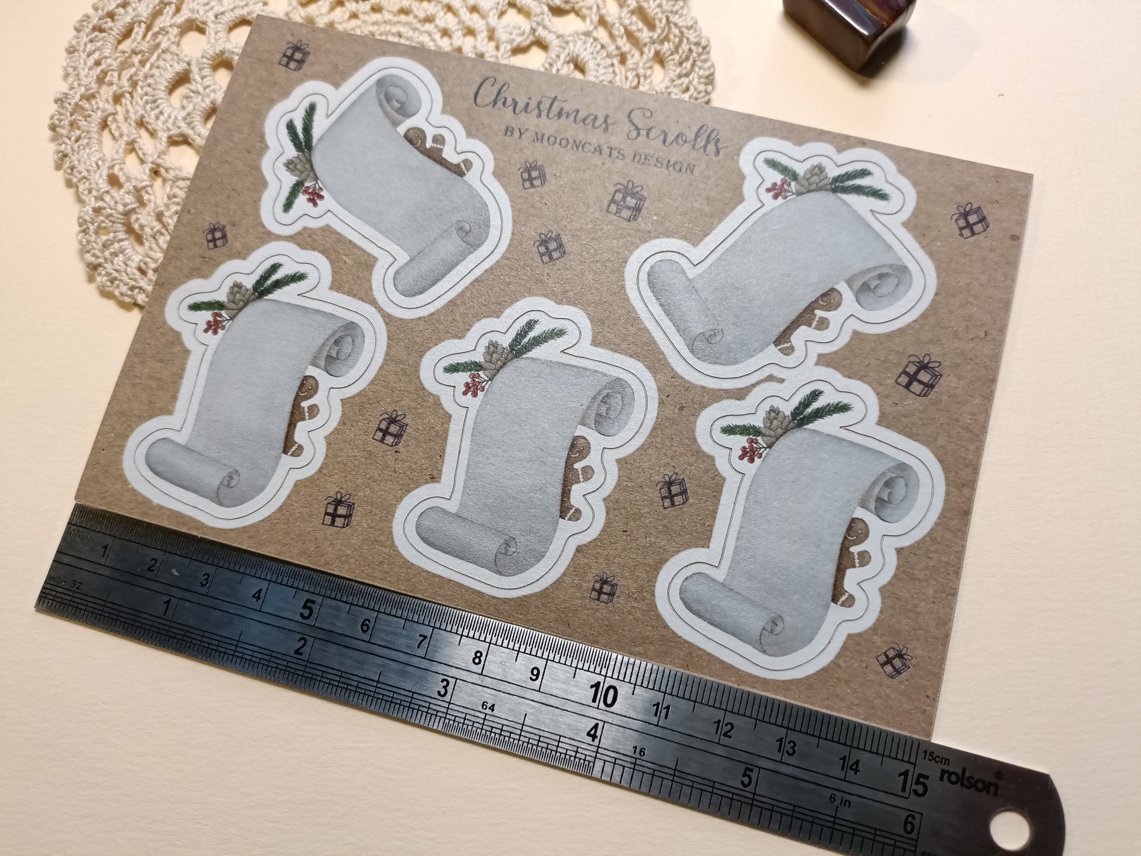 Sheet of Christmas-themed Scroll label stickers with a ruler for scale.