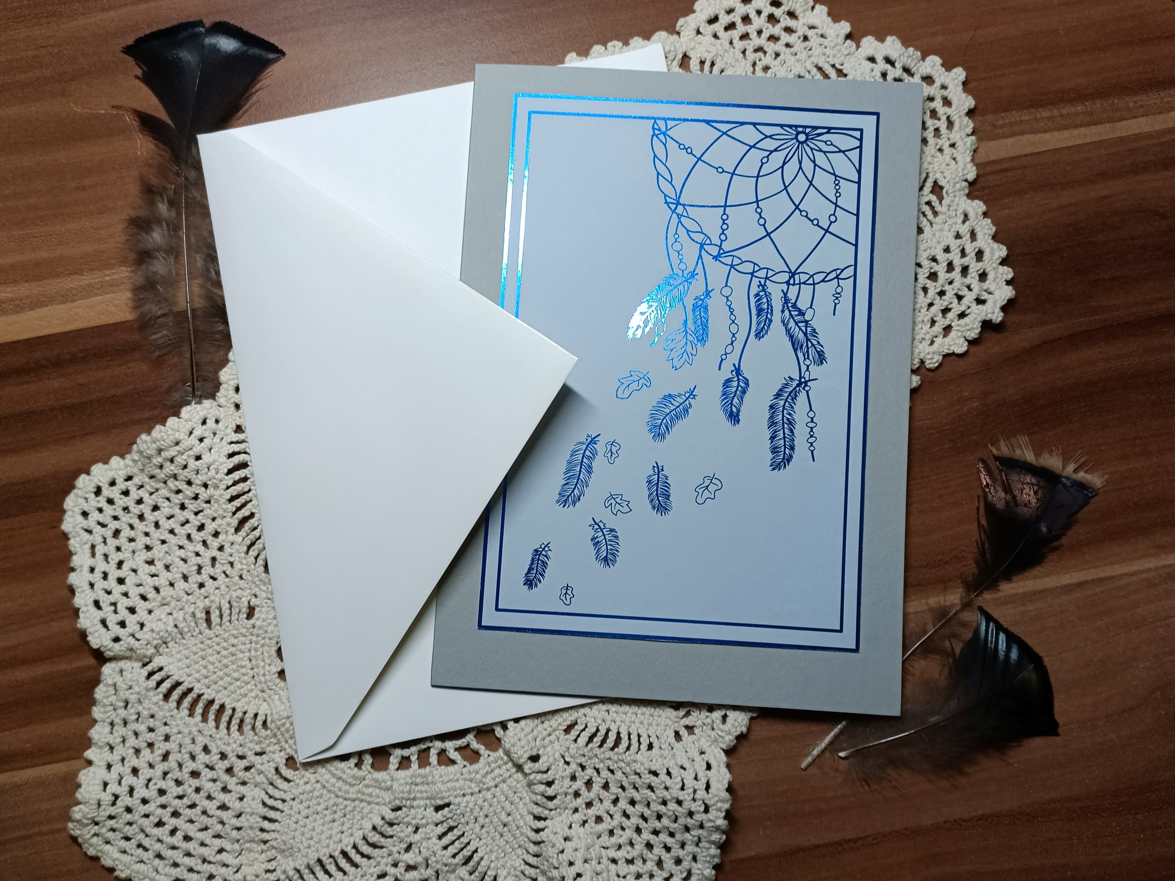 The grey/blue card with its closed envelope hugging it.