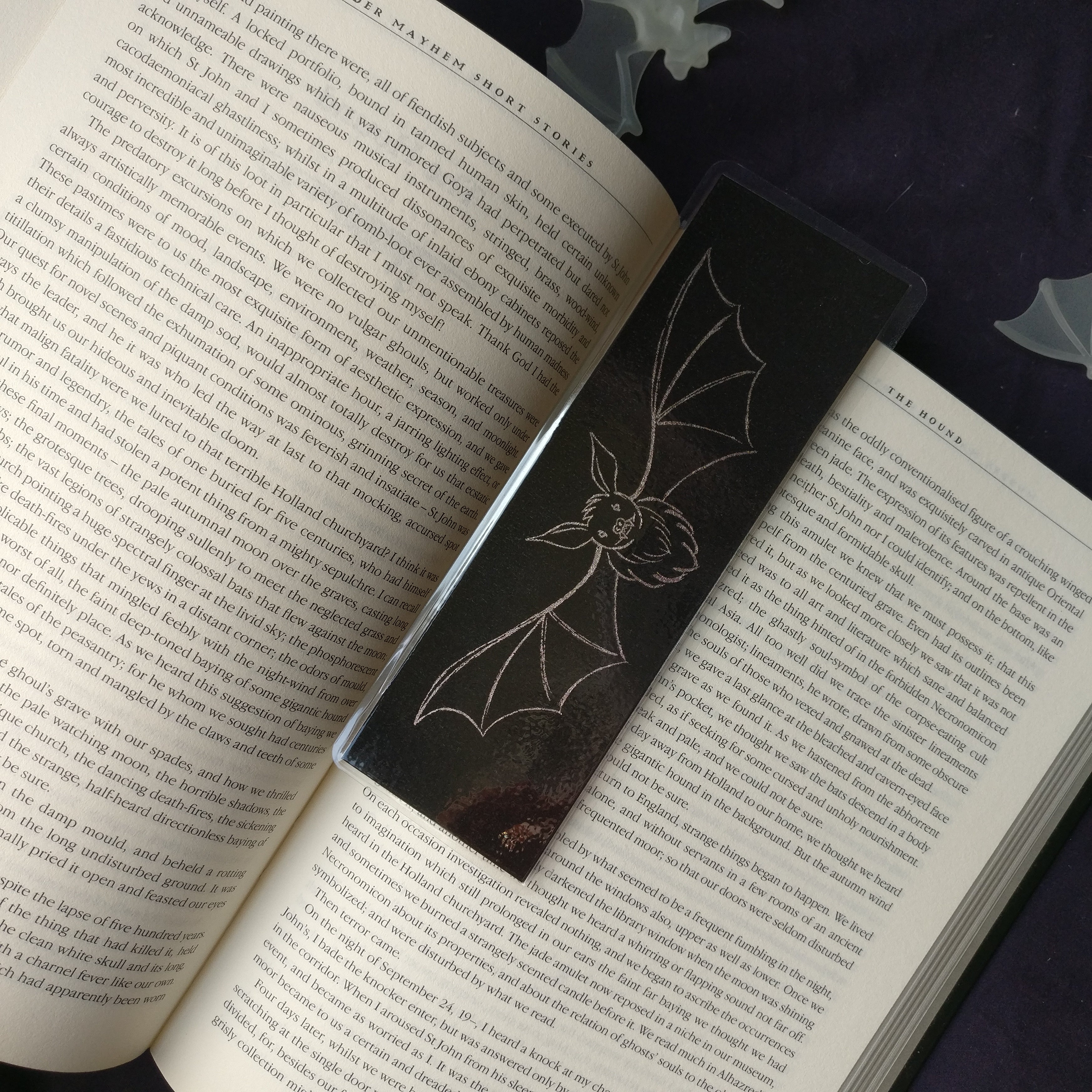The medium Shadow Bat Bookmark on an open book.
