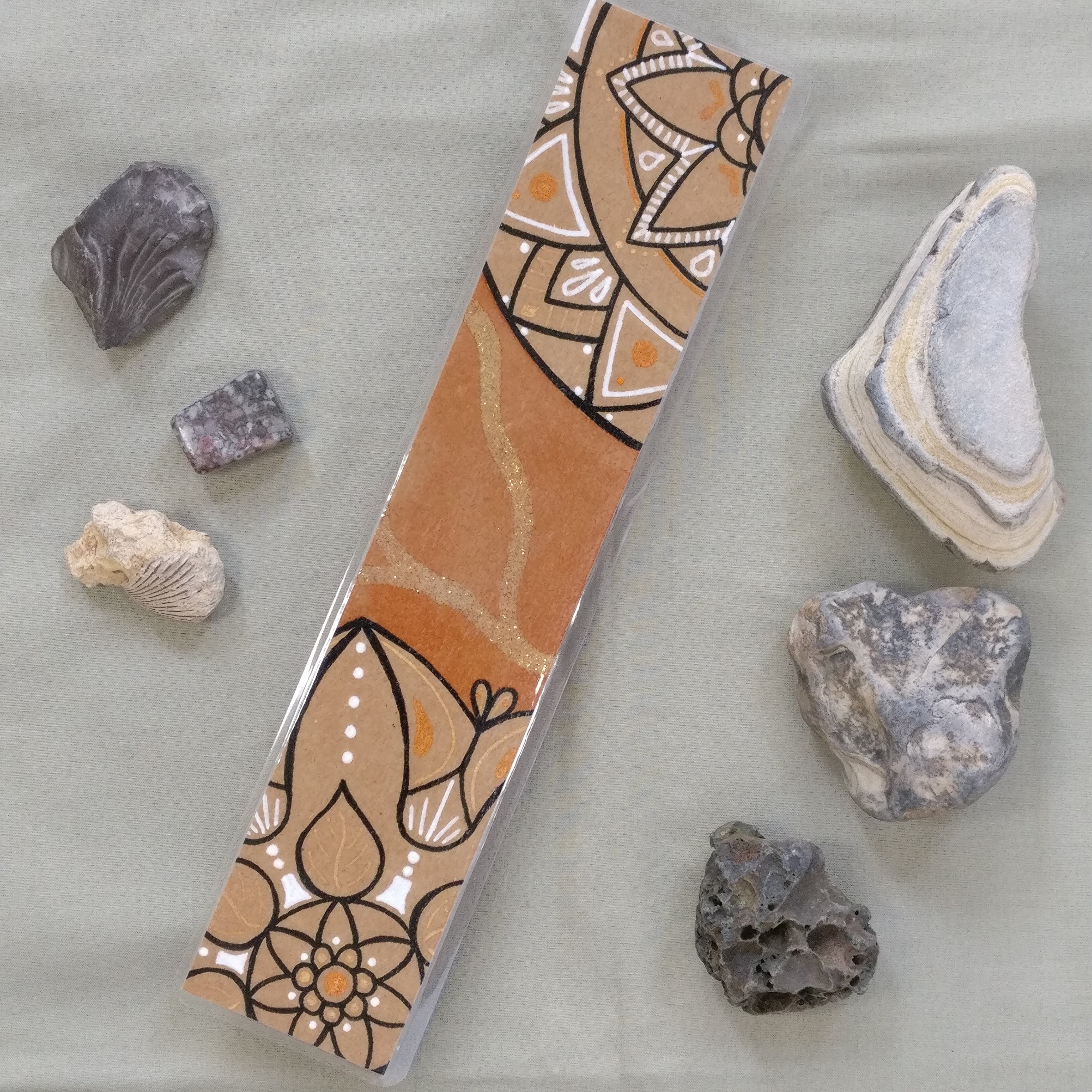 One of the orange Mandala bookmarks on its own in full view.