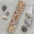 One of the aqua-coloured Mandala bookmarks on its own in full view.