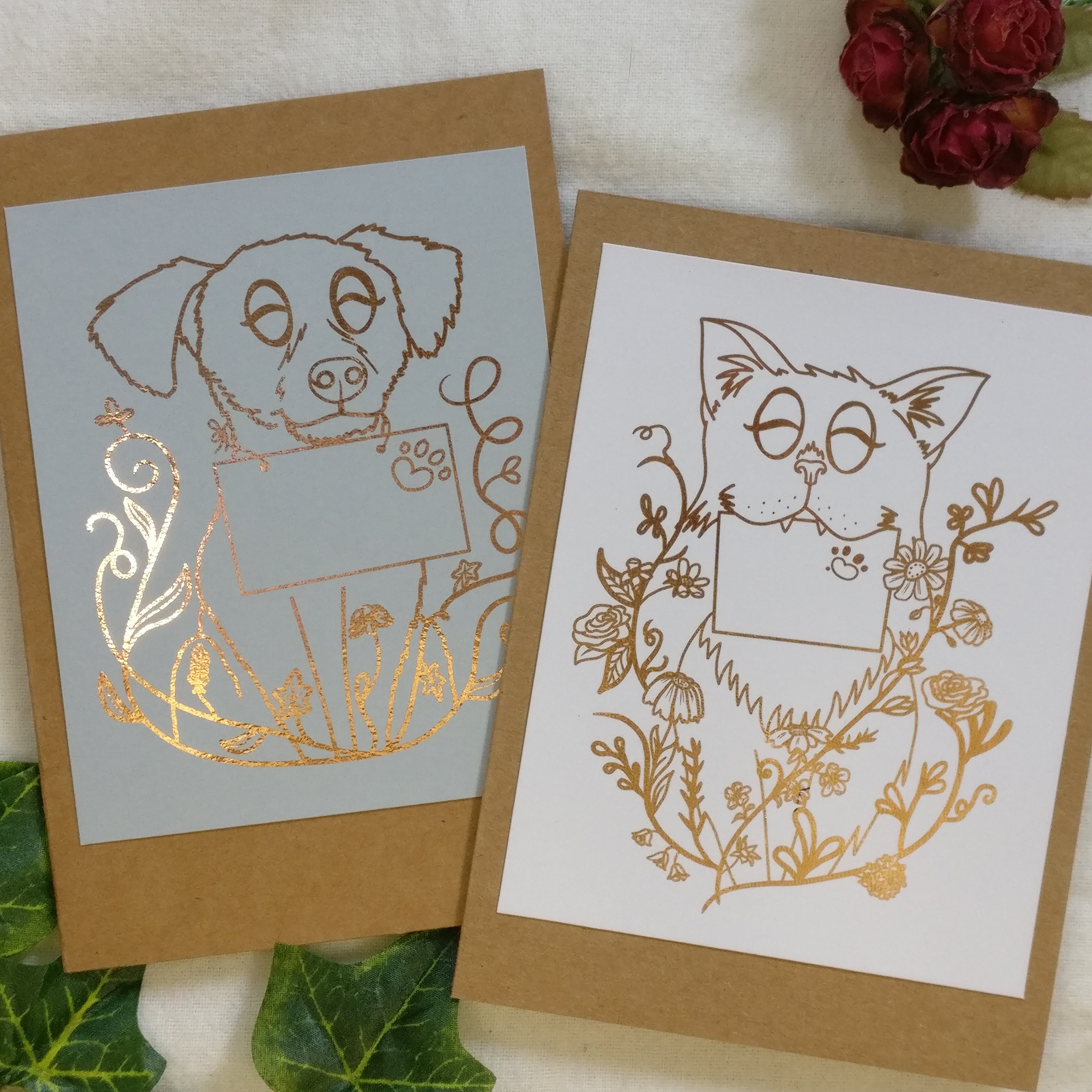 The two available "animal mail" designs: a dog on light grey and a cat on white, each illustration foiled by hand.