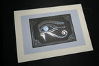 The silver foiled Eye of Horus print, mounted on a light grey backing.