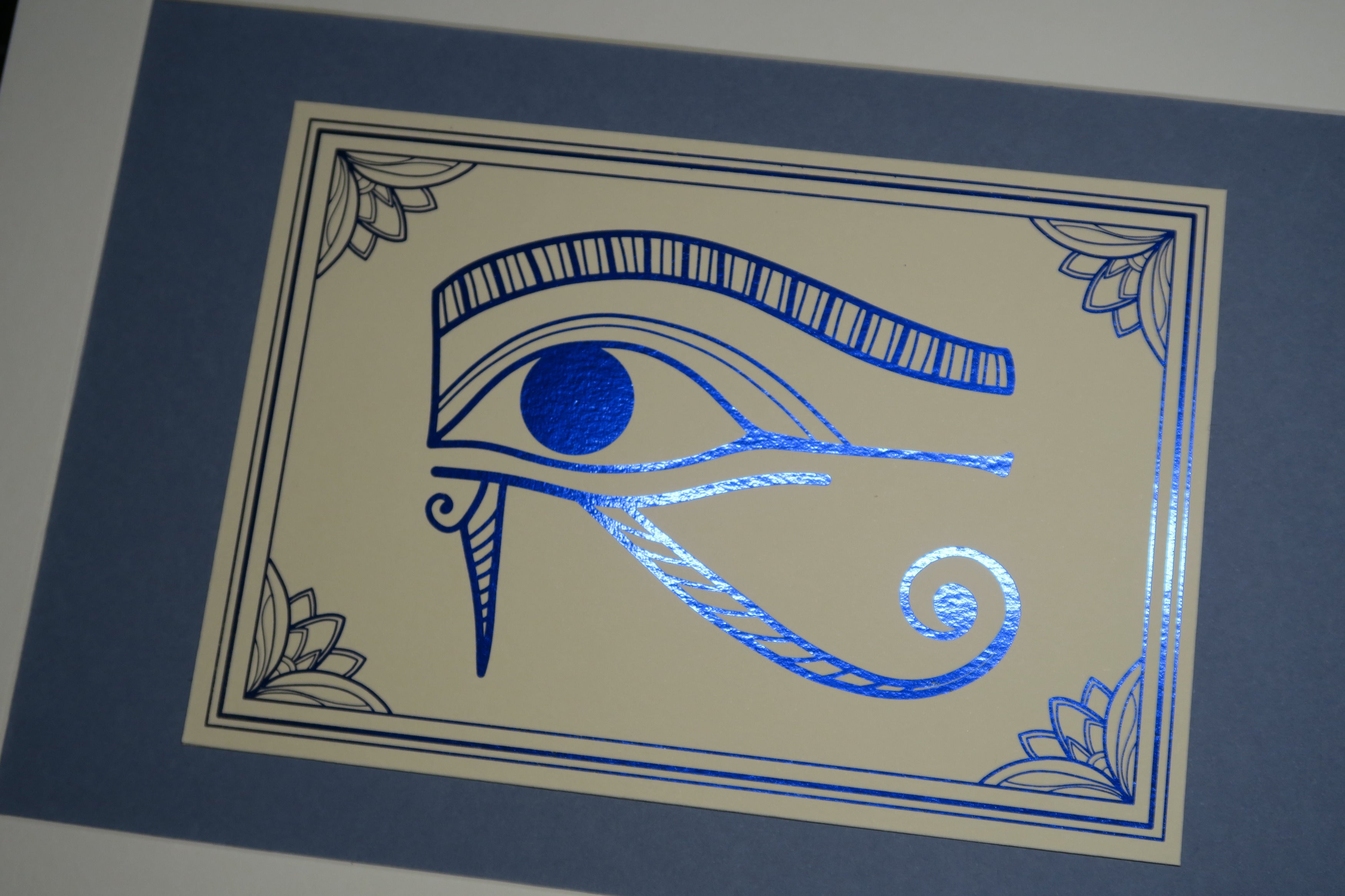 Closer view of the mounted blue foiled Eye of Horus print.
