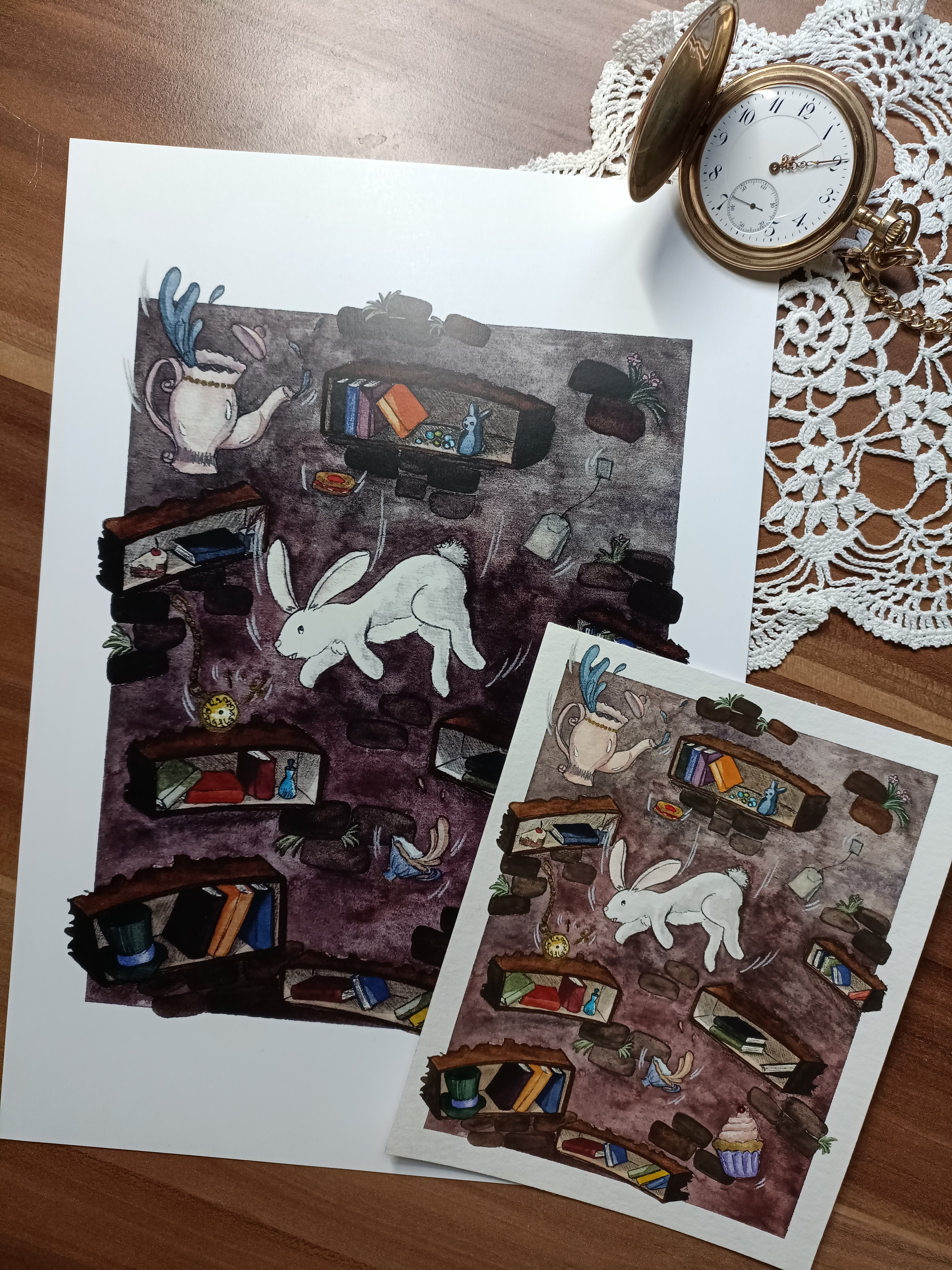 The art print "Down the Rabbit Hole" next to the original watercolour illustration.