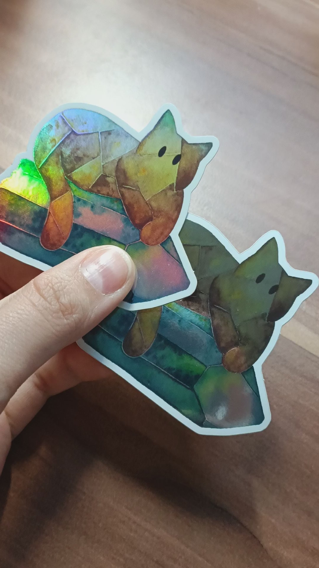 Short video of showing both the holographic and mirror version of the Crystal Cat Sticker.